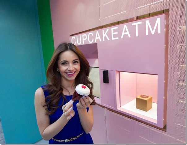NEW YORK - March 24,  2014. For Pulse/News. New York's first Cupcake ATM by the Sprinkles cupcake store is at 780 Lexington Avenue. Model Alexandra enjoys a cupcake from the machine.(photo by Tamara Beckwith/NY POST)